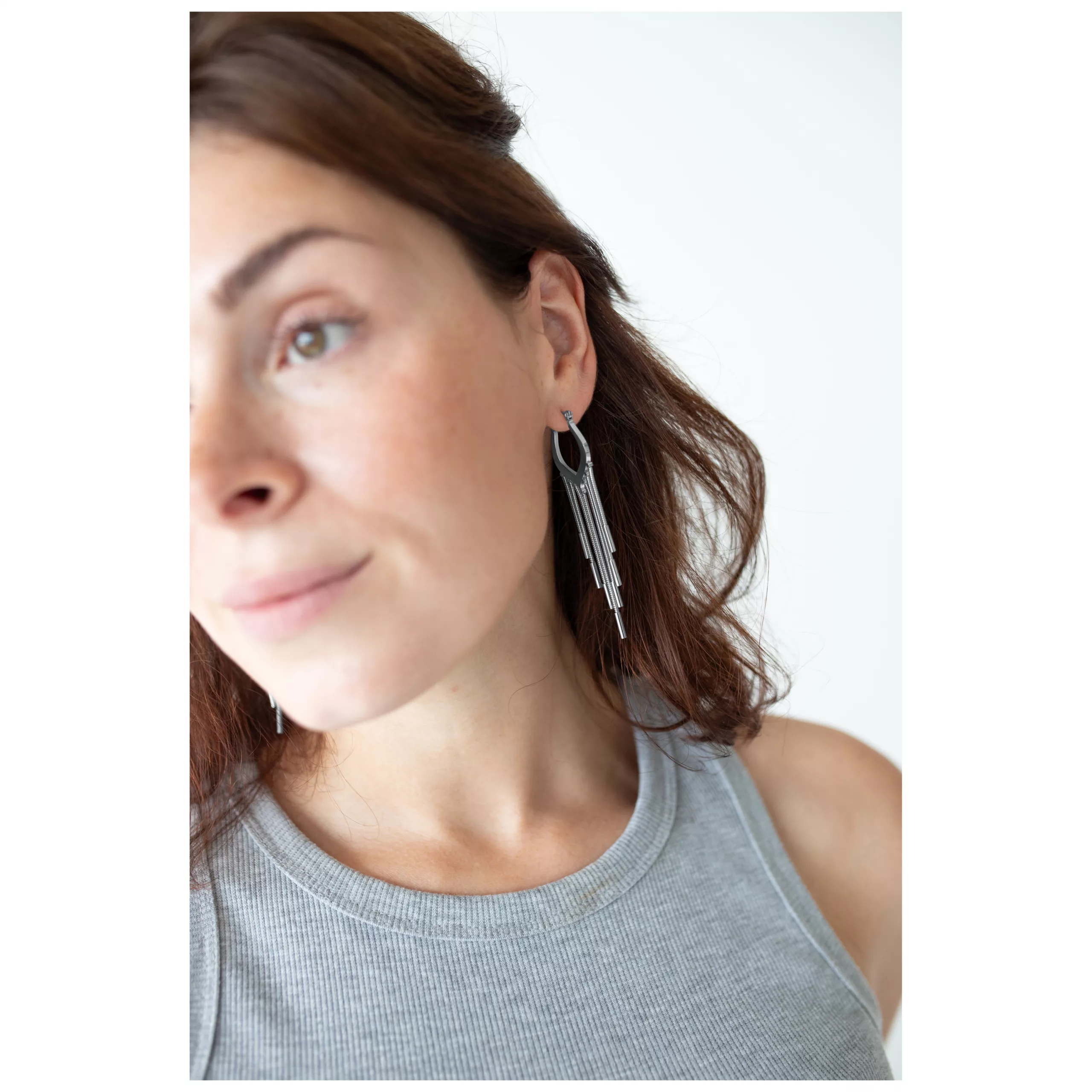 Elegante Snakechain Hoops in Silber Frau mit silbernen Snakechain Hoops Ohrringen vor weißem Hintergrund