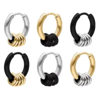 Set aus 5 kleinen Ringen in Schwarz, Silber, Gold Sechs kleine Ohrringe in Schwarz, Silber und Gold auf weißem Hintergrund