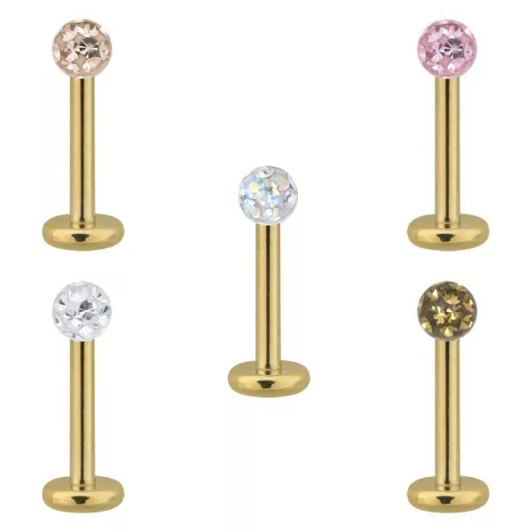 Goldenes Titan Labret mit Kristallen, 1,2 mm Fünf goldene Titan Labrets mit klaren und bunten Kristallen auf weißem Hintergrund