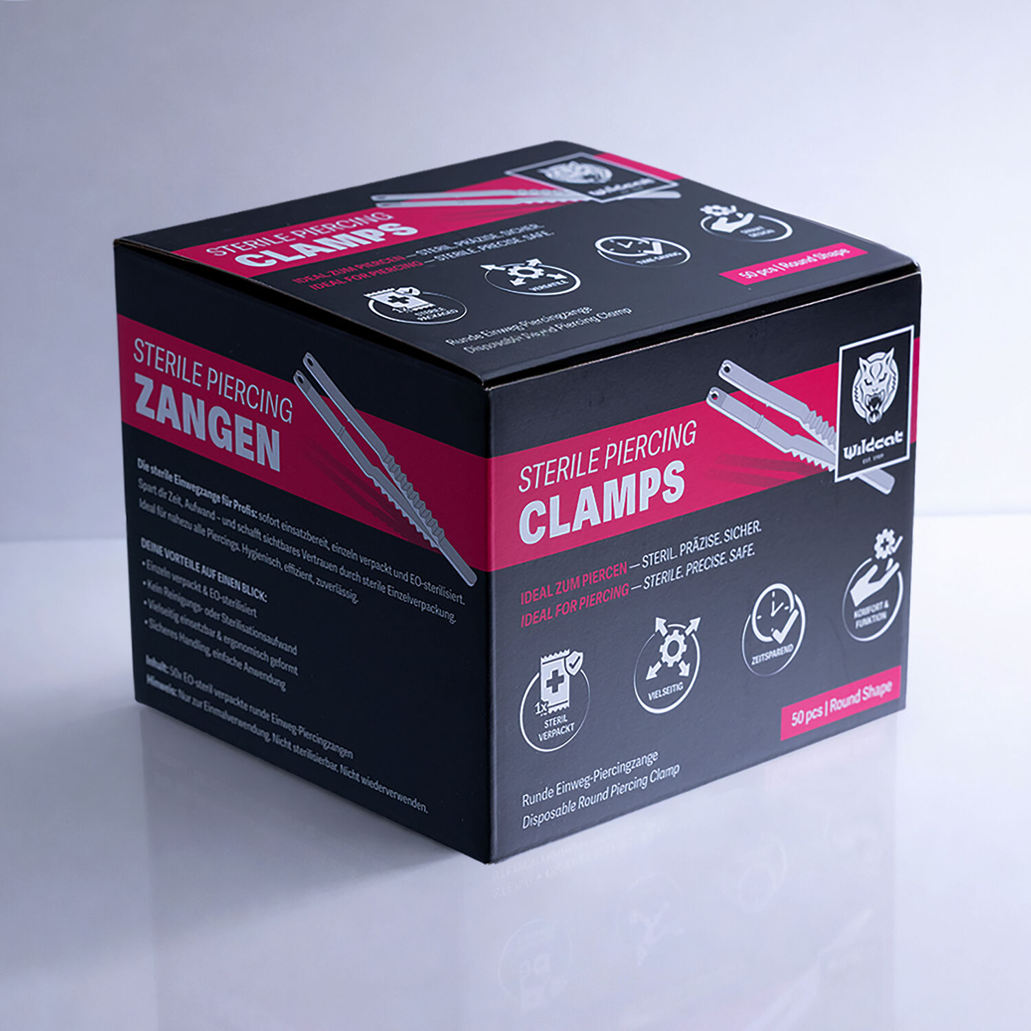 Sterile Runde Piercingzangen Verpackung Schwarze Box mit roten und weißen Schriftzügen auf grauem Hintergrund
